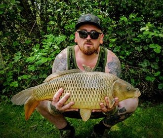Angler with a carp caught at Alderwood Fishery