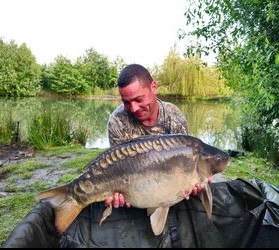 Angler with a carp caught at Alderwood Fishery