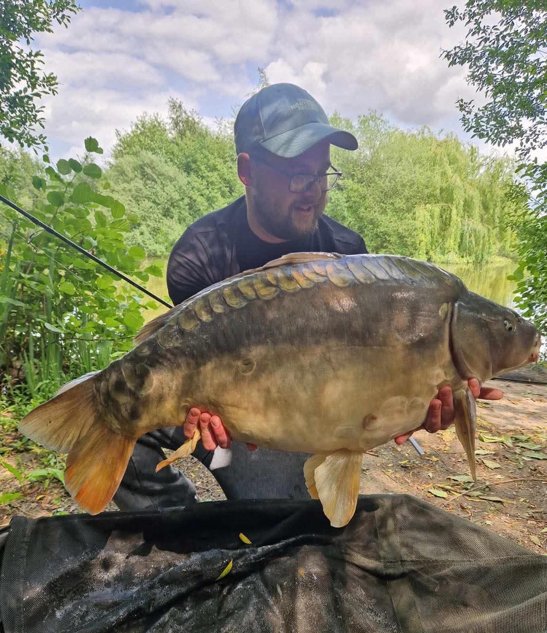 Angler with a carp caught at Alderwood Fishery