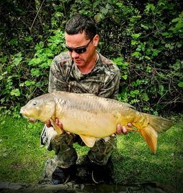Angler with a carp caught at Alderwood Fishery