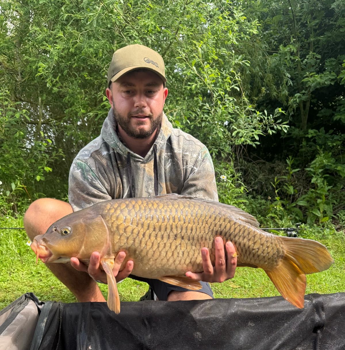 Angler with a carp caught at Alderwood Fishery