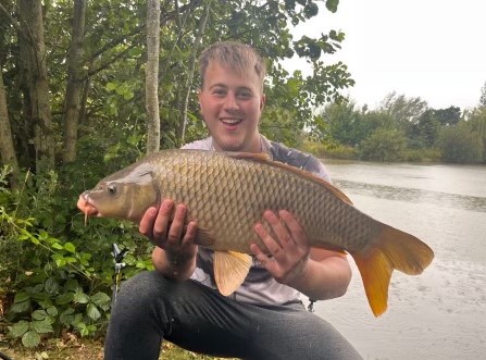Angler with a carp caught at Alderwood Fishery
