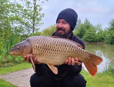 Angler with a 14lb 11oz carp caught at Alderwood Fishery