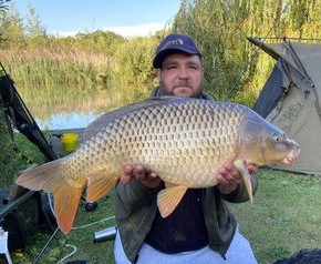 Angler with a carp caught at Alderwood Fishery