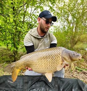 Angler with a carp caught at Alderwood Fishery