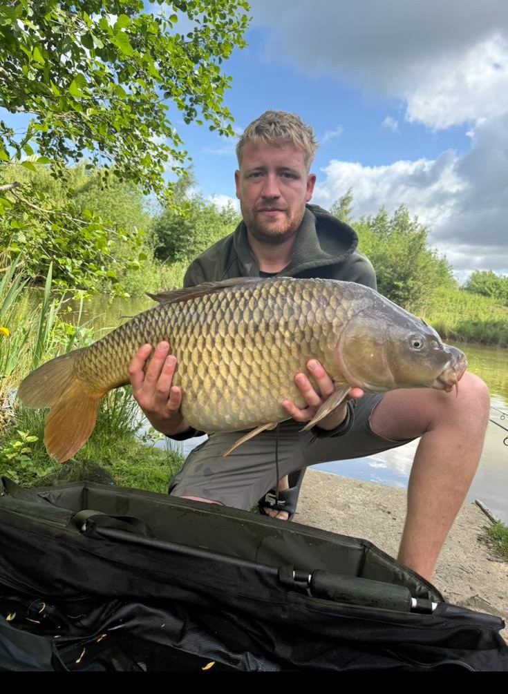 Angler with a carp caught at Alderwood Fishery