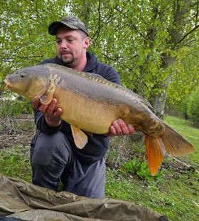 Angler with a carp caught at Alderwood Fishery