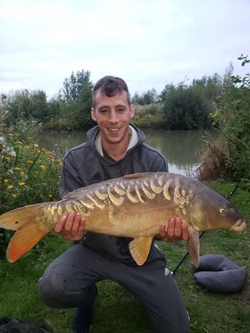 Angler with a carp caught at Alderwood Fishery